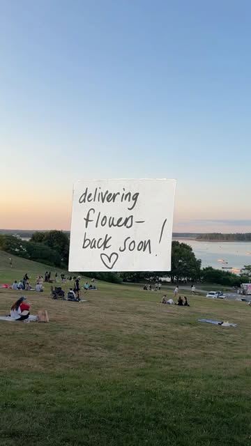 Sunset park view with a handwritten delivering flowers back soon note
